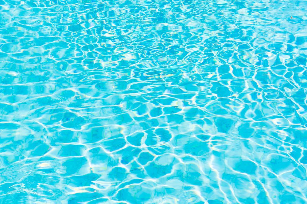 A pool with blue water and ripples on it.